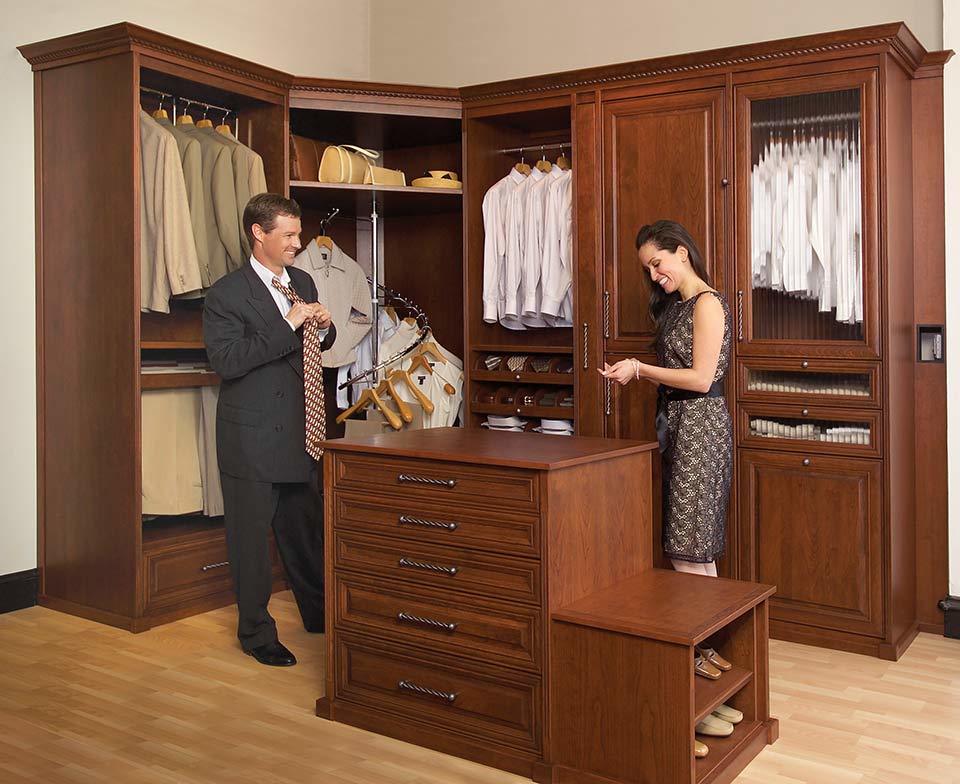 custom walk in closet, man and woman getting ready, island, cabinets